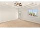 Spacious bedroom with a ceiling fan and a large window overlooking the neighborhood at 2660 Mirabella St, Henderson, NV 89052