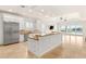 Bright, open kitchen featuring a large island, stainless steel appliances, and access to an outdoor patio at 2660 Mirabella St, Henderson, NV 89052