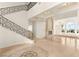 Bright, open living room with high ceilings and a fireplace with ornate stone mantel at 2660 Mirabella St, Henderson, NV 89052