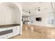 Open floor plan with a wet bar area, travertine floors, archways, and an open flow to the kitchen at 2660 Mirabella St, Henderson, NV 89052