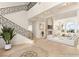 Bright, open living room with high ceilings, fireplace and staircase with ornate wrought iron railings at 2660 Mirabella St, Henderson, NV 89052