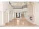 Bright living room featuring high ceilings, stone fireplace, and columns at 2660 Mirabella St, Henderson, NV 89052