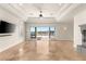 Spacious living room with travertine floors, recessed lights, sliding doors to the patio, and fireplace at 2660 Mirabella St, Henderson, NV 89052
