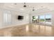 Living room features travertine floors, ceiling fans, and access to the outdoor patio and pool area at 2660 Mirabella St, Henderson, NV 89052