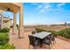 Outdoor patio with dining table, seating, views of the pool, and surrounding landscape at 2660 Mirabella St, Henderson, NV 89052