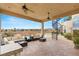 Outdoor patio featuring comfortable seating, a spiral staircase, and access to the pool and backyard area at 2660 Mirabella St, Henderson, NV 89052