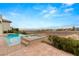 Backyard pool and hot tub with brick patio, desert landscaping, and scenic mountain views at 2660 Mirabella St, Henderson, NV 89052