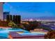 Enjoy stunning city views from this backyard oasis, featuring a pool, spa, and fire pit at 2660 Mirabella St, Henderson, NV 89052