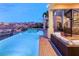 Sparkling pool and spa area with a spiral staircase, firepit and outdoor seating at 2660 Mirabella St, Henderson, NV 89052