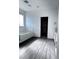 Bright bathroom featuring a tub with glass doors, and gray wood-look floors at 290 Mount Williamson St, Henderson, NV 89015