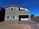 This exterior shows a two-story home, with a balcony over the patio area and neutral color palette at 290 Mount Williamson St, Henderson, NV 89015