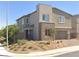 Charming two-story home featuring desert landscaping and stone accents on the facade and garage at 290 Mount Williamson St, Henderson, NV 89015