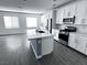 Modern kitchen features stainless steel appliances, quartz countertops, and center island with sink at 290 Mount Williamson St, Henderson, NV 89015