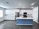 Bright kitchen boasts white cabinets, stainless steel appliances, large island, and modern finishes at 290 Mount Williamson St, Henderson, NV 89015