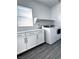 Clean and bright laundry room with white cabinets and modern washer and dryer at 290 Mount Williamson St, Henderson, NV 89015