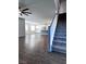 Open-concept living room and kitchen area with wood-style flooring and staircase at 290 Mount Williamson St, Henderson, NV 89015