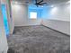 A loft area with neutral carpet, white walls, and a ceiling fan at 290 Mount Williamson St, Henderson, NV 89015