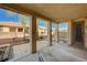 Spacious covered patio looking out onto a landscaped backyard with privacy walls and a lounge swing at 317 Shimmering Moon St, Henderson, NV 89015