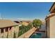 A lush backyard with a sparkling pool and view of neighboring houses surrounded by mature landscaping at 317 Shimmering Moon St, Henderson, NV 89015
