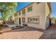 Backyard showcasing a covered patio, second-story deck, lounge swing, and a cozy fire pit area at 317 Shimmering Moon St, Henderson, NV 89015