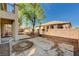 Backyard with a patio, tree, and swing set against a brick wall for outdoor relaxation at 317 Shimmering Moon St, Henderson, NV 89015