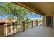 This is a shot of a balcony with black metal railings, tan pillars, and an overhanging ceiling at 317 Shimmering Moon St, Henderson, NV 89015