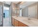 This is a shot of a bathroom with double sinks, a large mirror, and a walk-in shower at 317 Shimmering Moon St, Henderson, NV 89015