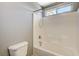 Bathroom showcasing a shower-tub combination with tiled walls and modern fixtures, and a commode at 317 Shimmering Moon St, Henderson, NV 89015