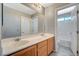 A well-lit bathroom features a double sink vanity and a doorway leading to a separate toilet and shower area at 317 Shimmering Moon St, Henderson, NV 89015