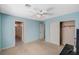 This bedroom has blue walls, white ceilings, and white trim around the doors and closet at 317 Shimmering Moon St, Henderson, NV 89015