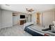 Open bedroom space with TV, ceiling fan, and view to ensuite bath and cabinet at 317 Shimmering Moon St, Henderson, NV 89015