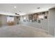 Large bonus room featuring a built-in bar, neutral carpet, and ample natural light at 317 Shimmering Moon St, Henderson, NV 89015