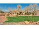 Well-maintained common area featuring grass, rocks, and walking path at 317 Shimmering Moon St, Henderson, NV 89015