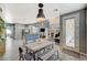 Open-concept dining area with stylish lighting, seating, and an easy flow to the living room and kitchen at 317 Shimmering Moon St, Henderson, NV 89015