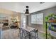 Cozy dining area with wood-look floors, stylish light fixture, and views of the living area and outdoor access at 317 Shimmering Moon St, Henderson, NV 89015