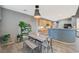 Inviting dining space featuring light gray walls, a modern table with seating, and decorative plants at 317 Shimmering Moon St, Henderson, NV 89015