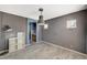 Bright, versatile room with stylish wood-look tile flooring and modern pendant lighting at 317 Shimmering Moon St, Henderson, NV 89015