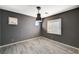 Versatile empty room featuring wood-look tile flooring, neutral paint, and modern pendant lighting at 317 Shimmering Moon St, Henderson, NV 89015