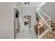 Bright foyer featuring tile floors, staircase, and a view into the living spaces at 317 Shimmering Moon St, Henderson, NV 89015