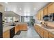 Well-designed kitchen flows into the dining area with wood cabinets, granite counters, and modern appliances at 317 Shimmering Moon St, Henderson, NV 89015