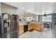 Functional kitchen offers wood cabinets, granite counters, stainless steel appliances, and a seamless dining area connection at 317 Shimmering Moon St, Henderson, NV 89015