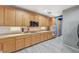 Bright kitchen boasts wood cabinets, granite counters, stainless appliances, and sleek flooring for modern appeal at 317 Shimmering Moon St, Henderson, NV 89015