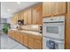 Well-lit kitchen featuring wooden cabinetry, marble countertops, and modern appliances at 317 Shimmering Moon St, Henderson, NV 89015
