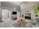 Open living room featuring a fireplace and seamless transition to other living spaces at 317 Shimmering Moon St, Henderson, NV 89015