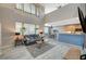 Spacious living room features large windows and open concept layout to the kitchen at 317 Shimmering Moon St, Henderson, NV 89015