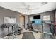 Fully equipped home gym with weightlifting equipment, treadmill, bike, and TV at 317 Shimmering Moon St, Henderson, NV 89015