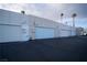 Commercial building exterior showing multiple units with roll-up doors and a parking area at 3467 Garden East Dr, Las Vegas, NV 89121
