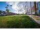 Well-maintained townhouse complex with lush green lawn, landscaping, and mature trees at 3467 Garden East Dr, Las Vegas, NV 89121