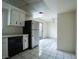 Bright eat-in kitchen with white cabinets, tile flooring, black appliances, and access to outdoor area at 3467 Garden East Dr, Las Vegas, NV 89121