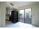 View of kitchen with tile flooring, black appliances, white cabinets, and a sliding glass door at 3467 Garden East Dr, Las Vegas, NV 89121